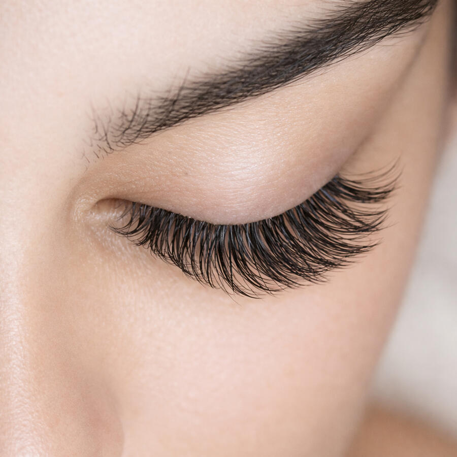 Eyelash Extensions Comparison photo showing four styles of eyelash extensions: Classic, Hybrid, Volume, and Mega Volume on different clients’ eyes.